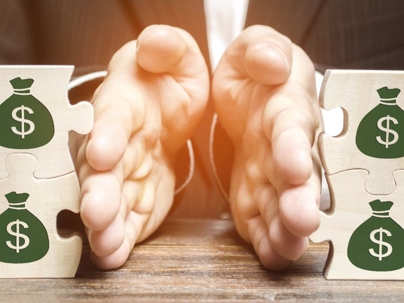 businessman-separates-the-wooden-puzzle-with-a-picture-of-money-the-picture-id1166401946